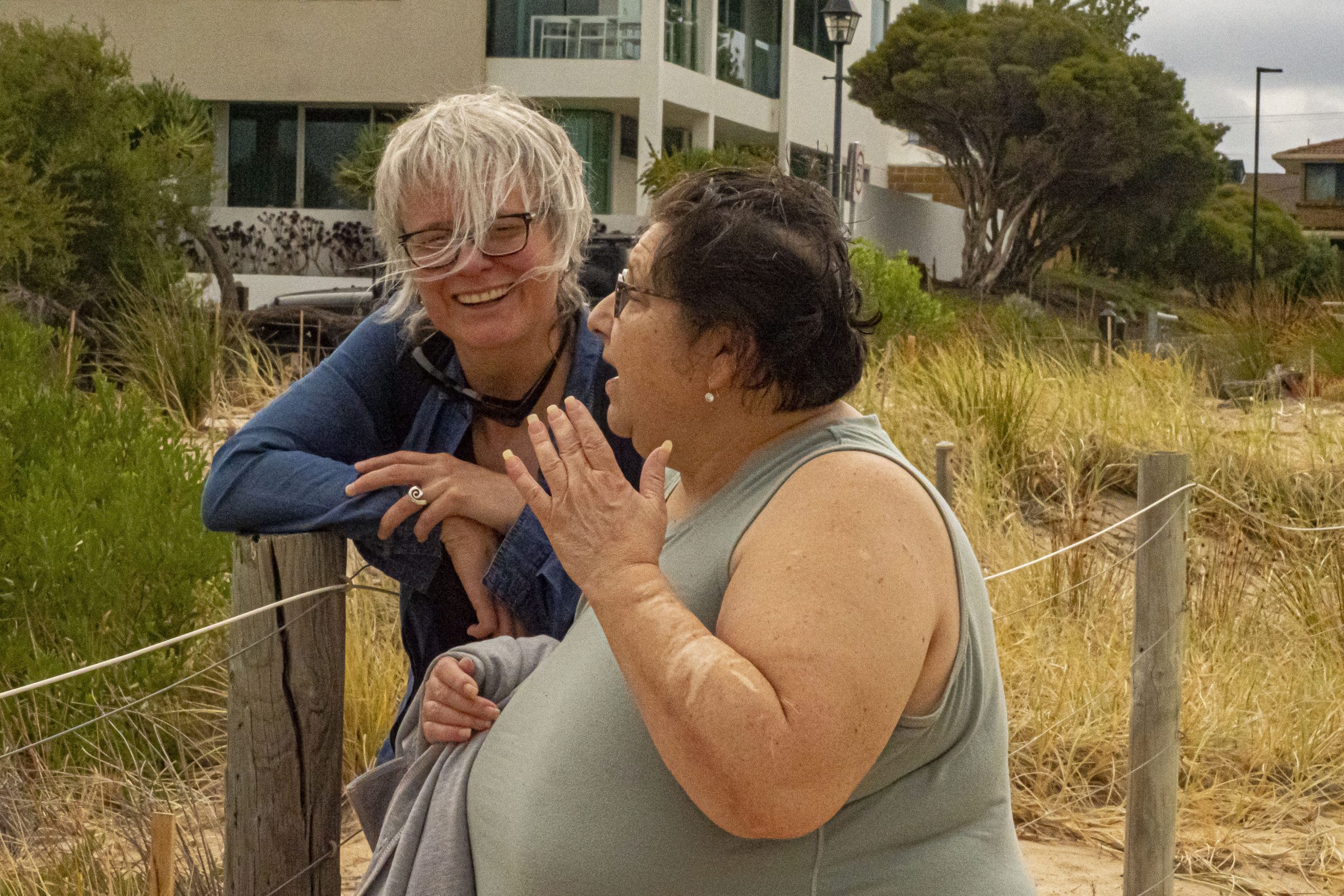 Female support worker with community member at beach